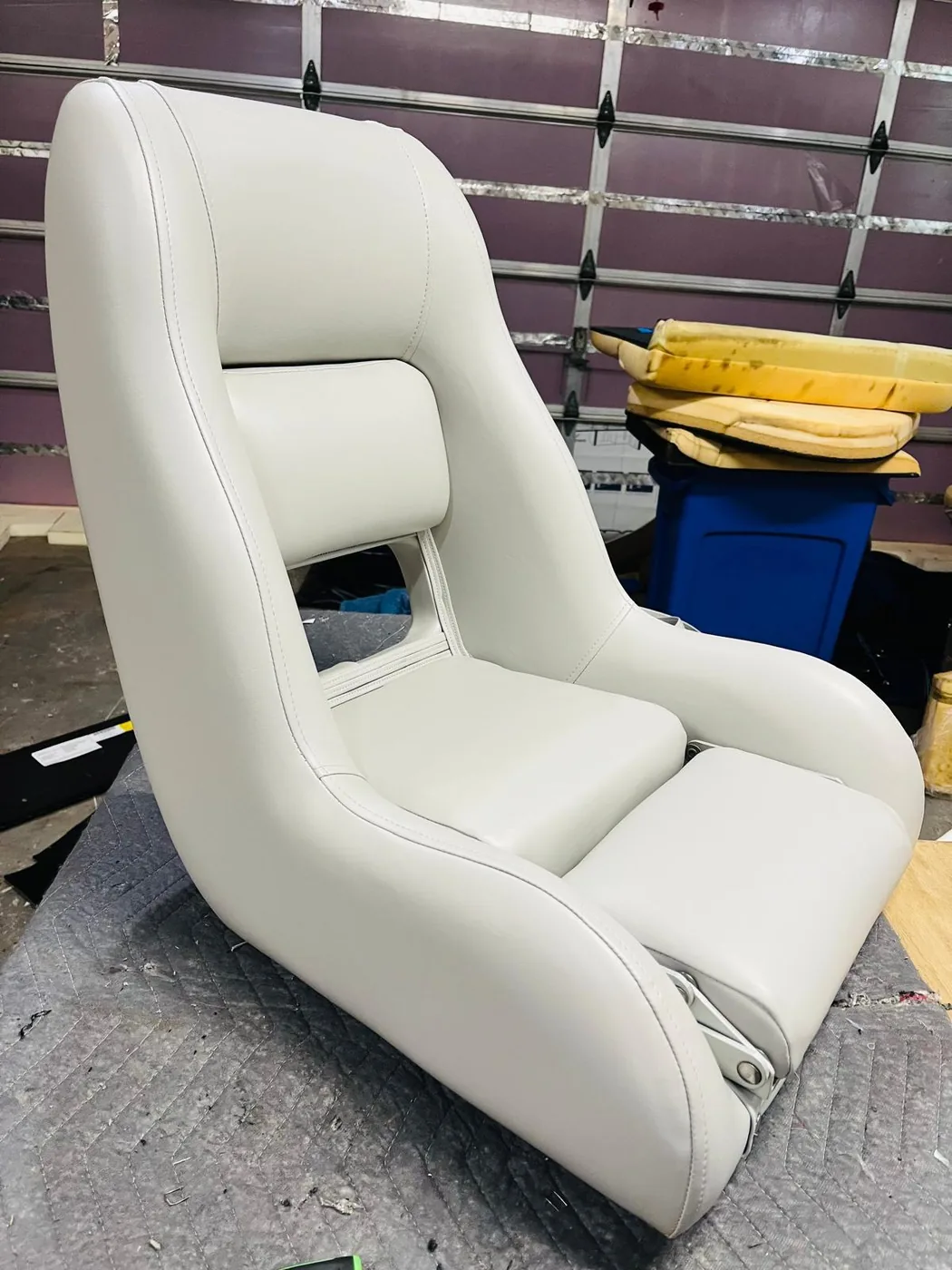 Restored white boat seat after upholstery restoration